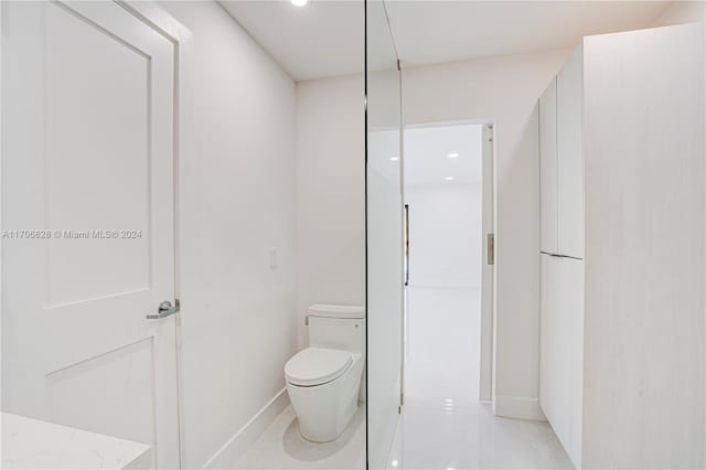 bathroom with tile patterned flooring and toilet