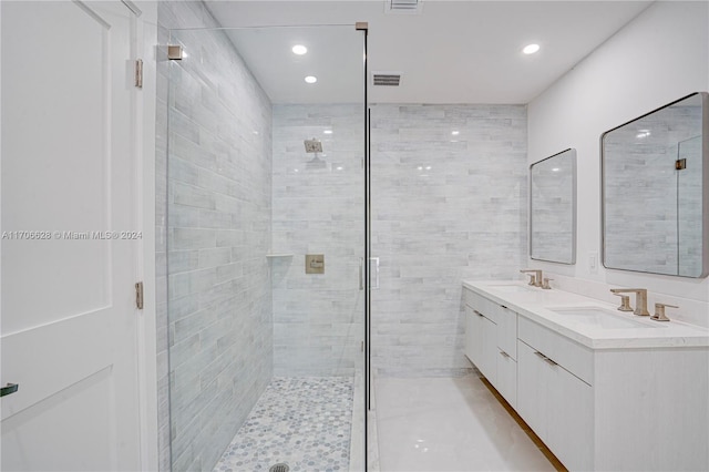 bathroom with a shower with door and vanity