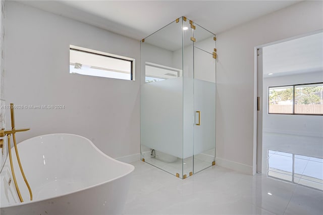 bathroom featuring separate shower and tub