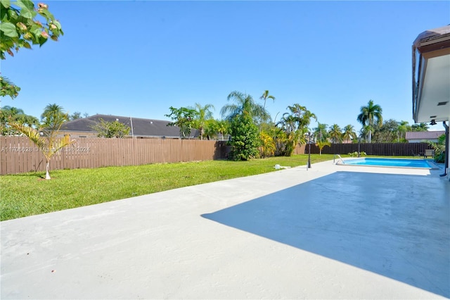 view of swimming pool featuring a lawn and a patio area