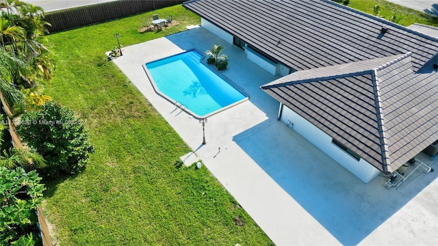 view of swimming pool with a yard and a patio