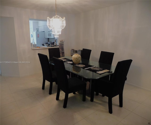 tiled dining space featuring an inviting chandelier