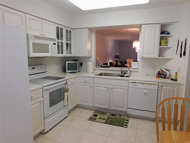 kitchen featuring white cabinets, white appliances, sink, and light tile patterned floors