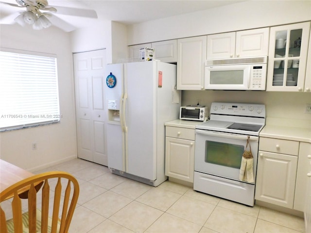 kitchen featuring white cabinetry, light tile patterned floors, ceiling fan, and white appliances