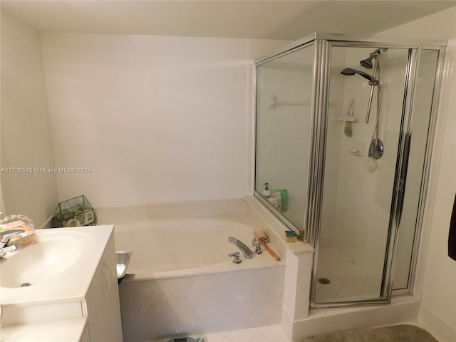 bathroom with tile patterned flooring, vanity, and independent shower and bath