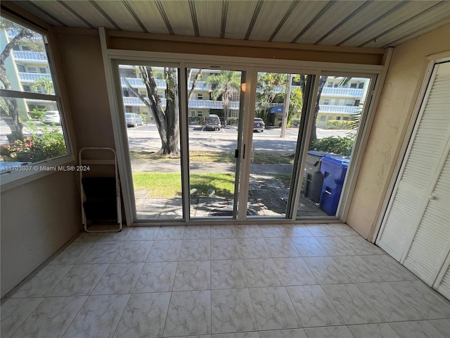 doorway with a wealth of natural light and wooden ceiling