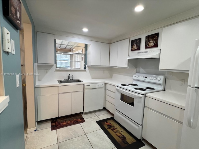 kitchen with light tile patterned floors, white cabinets, white appliances, and sink