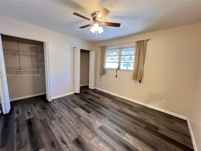 unfurnished bedroom featuring a textured ceiling, ceiling fan, and dark wood-type flooring