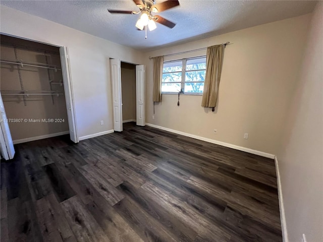 unfurnished bedroom featuring ceiling fan, dark hardwood / wood-style flooring, and a textured ceiling