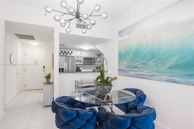 tiled dining space featuring an inviting chandelier