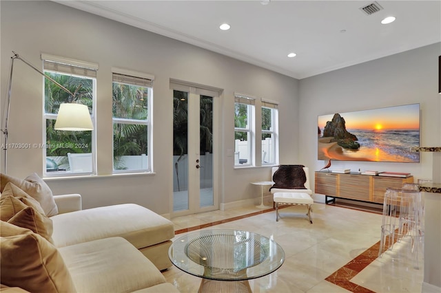 interior space with a wealth of natural light, french doors, and ornamental molding