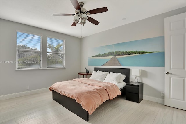 bedroom with light hardwood / wood-style flooring and ceiling fan