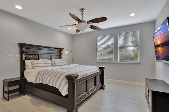 bedroom with ceiling fan and light hardwood / wood-style floors