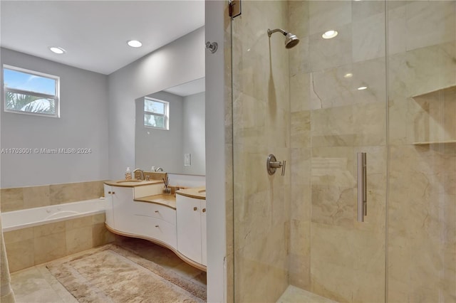 bathroom with vanity, shower with separate bathtub, and a wealth of natural light