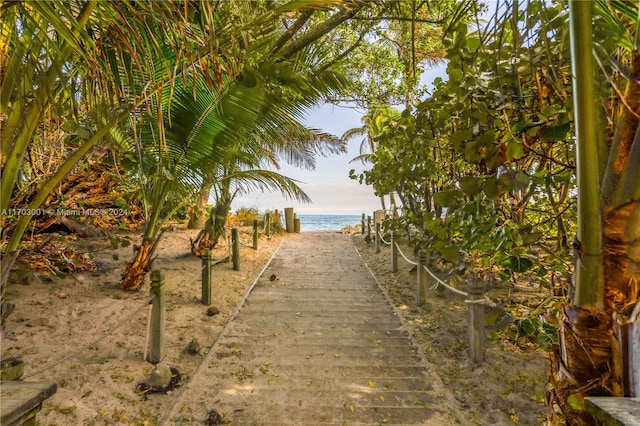 surrounding community featuring a view of the beach and a water view