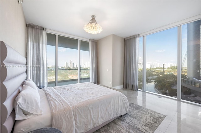 bedroom featuring floor to ceiling windows, a chandelier, multiple windows, and access to exterior