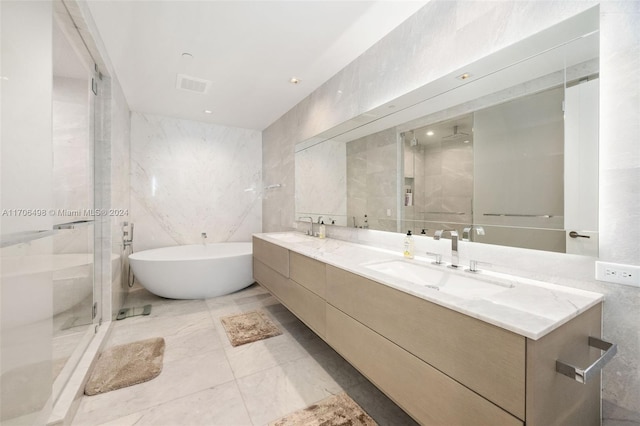 bathroom featuring vanity, separate shower and tub, and tile walls