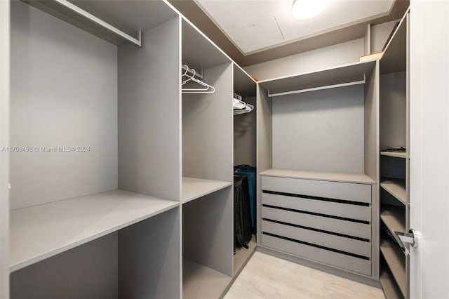 walk in closet featuring light tile patterned floors