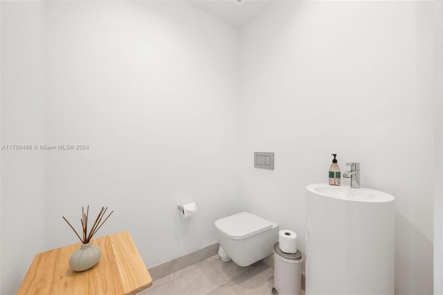 bathroom featuring tile patterned flooring and toilet