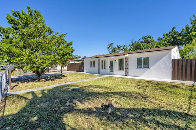 back of property featuring a lawn