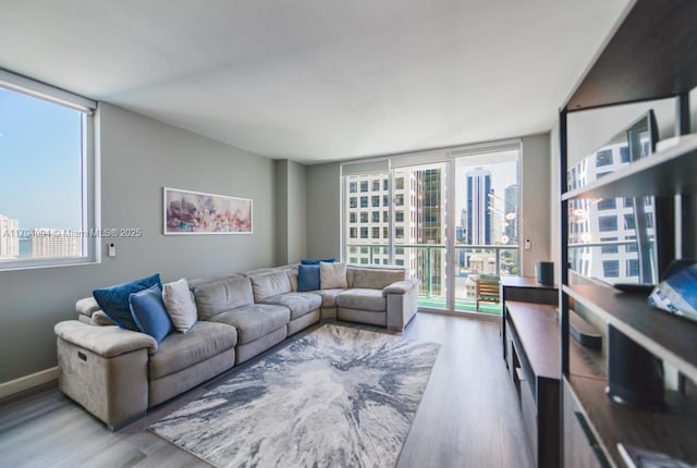 living room featuring floor to ceiling windows, plenty of natural light, and hardwood / wood-style floors