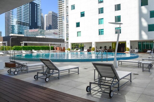 view of swimming pool featuring a patio area