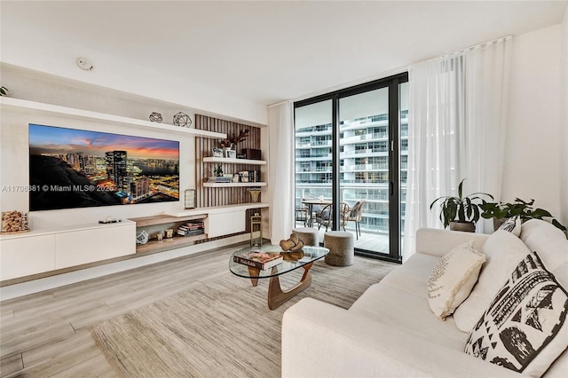 living room featuring wood finished floors and floor to ceiling windows