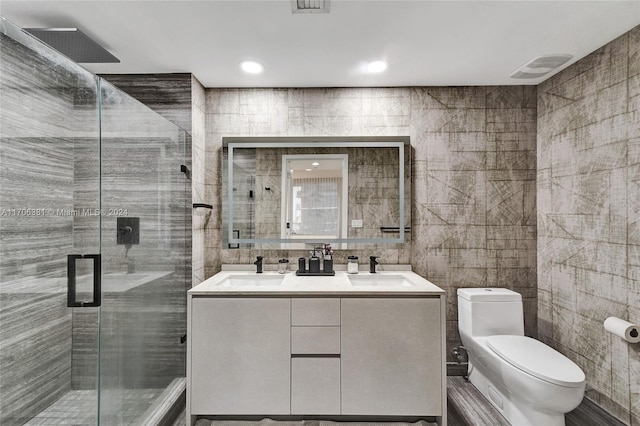 bathroom with vanity, an enclosed shower, tile walls, and toilet