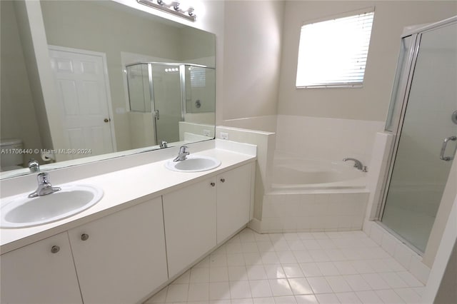 bathroom with tile patterned flooring, vanity, and independent shower and bath