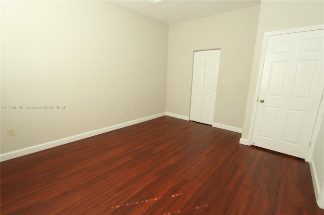 unfurnished bedroom featuring dark wood-type flooring