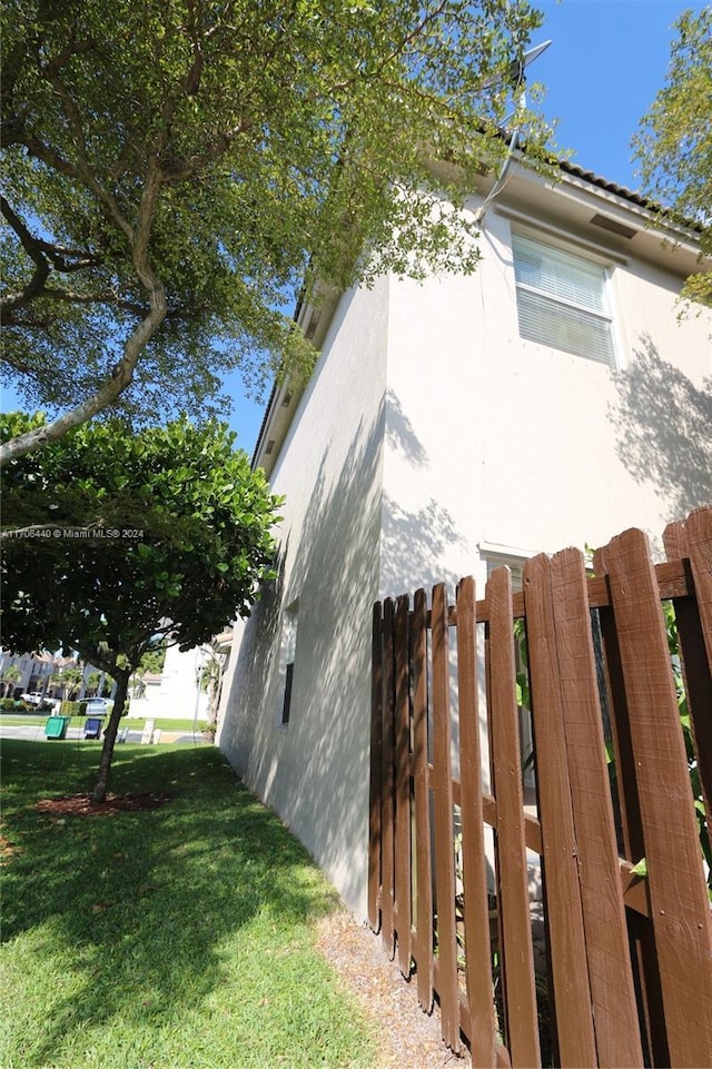 view of side of home with a yard