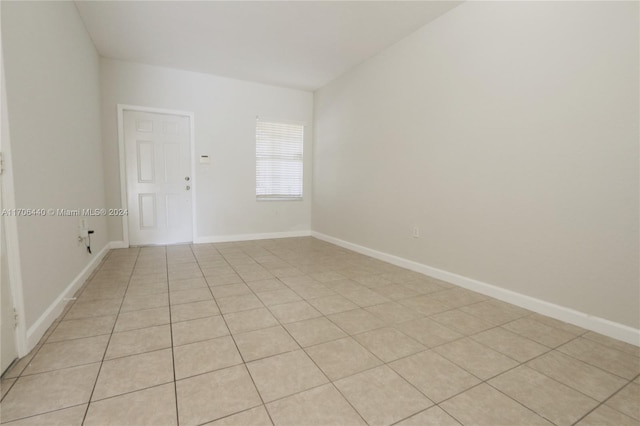 unfurnished room with light tile patterned flooring