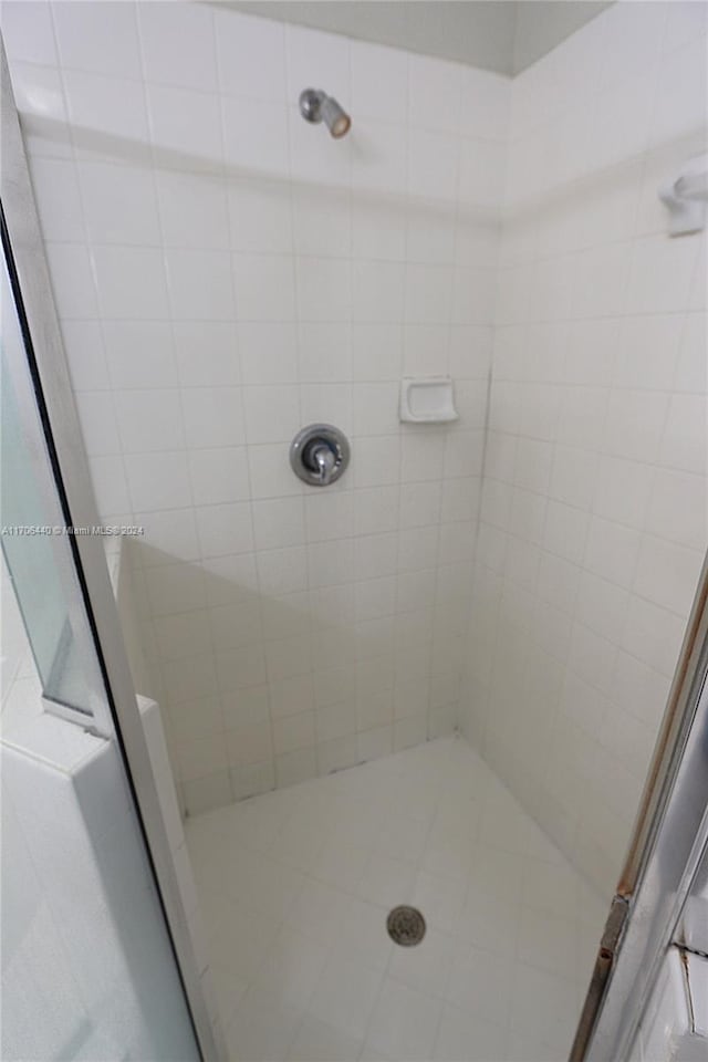 bathroom featuring a shower with shower door