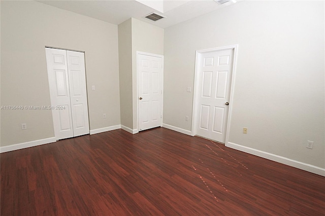 unfurnished bedroom featuring dark hardwood / wood-style flooring