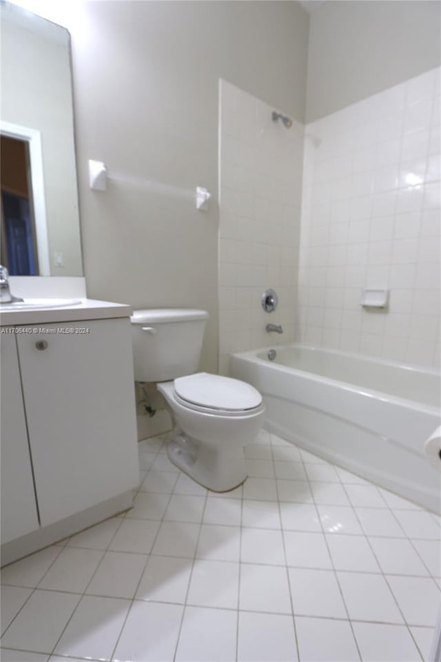 full bathroom featuring tile patterned floors, vanity, toilet, and tiled shower / bath combo