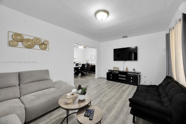 living room with hardwood / wood-style floors and ceiling fan