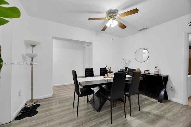 dining space featuring ceiling fan and light wood-type flooring