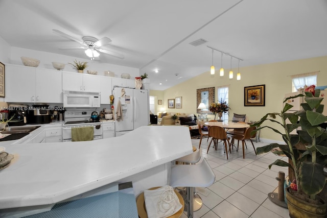 kitchen featuring white appliances, white cabinets, hanging light fixtures, vaulted ceiling, and ceiling fan