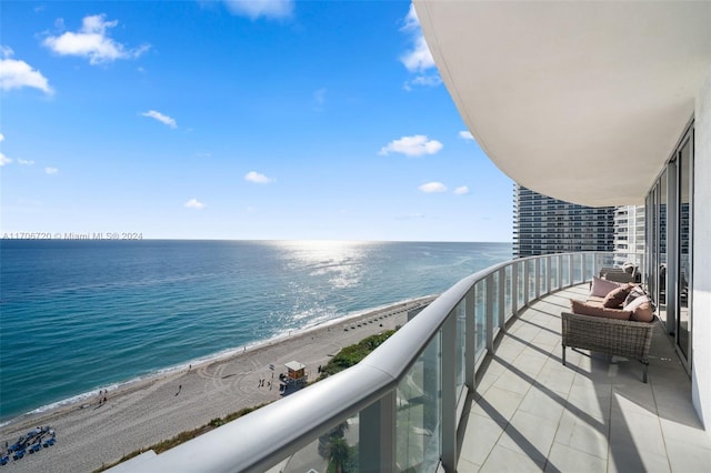 balcony with a water view and a beach view