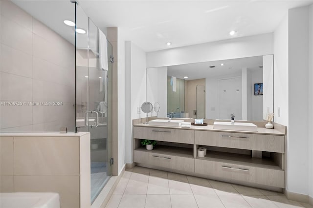 bathroom with tile patterned flooring, vanity, and an enclosed shower