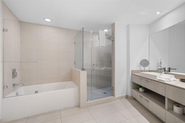 bathroom with vanity, tile patterned flooring, and plus walk in shower