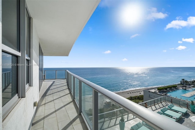 balcony with a water view and a beach view