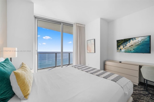 bedroom featuring access to exterior and a wall of windows