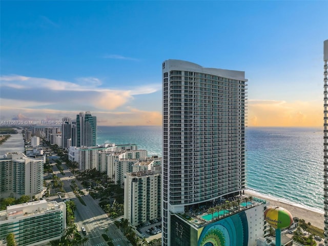 exterior space featuring a water view and a beach view