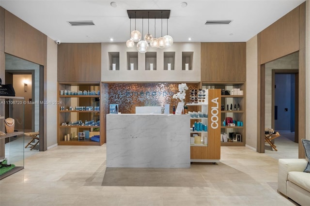 kitchen with wooden walls and decorative light fixtures