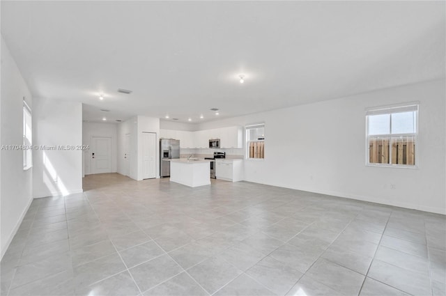 unfurnished living room with light tile patterned floors