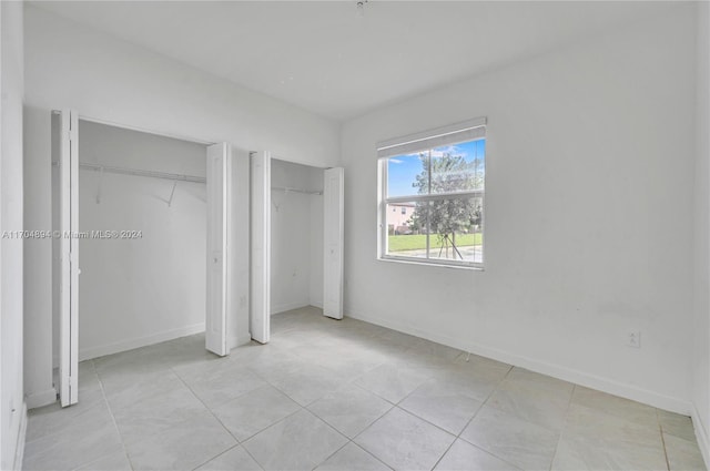 unfurnished bedroom with light tile patterned floors