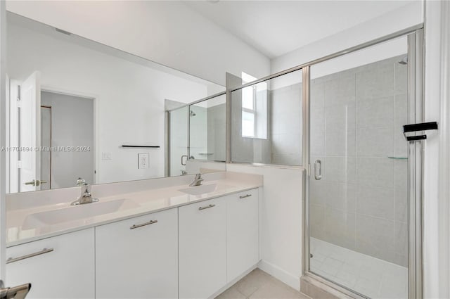 bathroom with vanity, tile patterned floors, and a shower with door