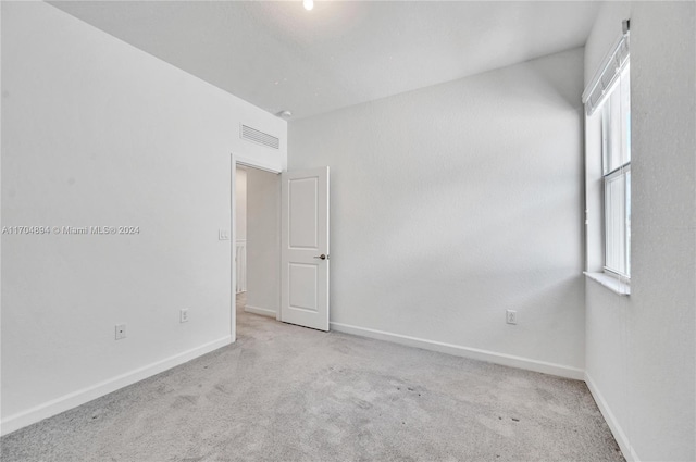 spare room with light colored carpet