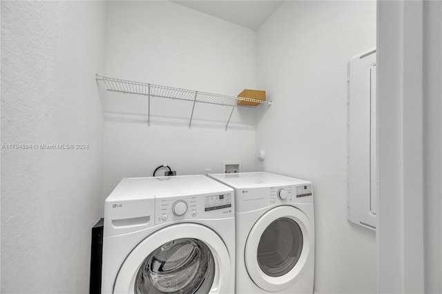 laundry room featuring washing machine and clothes dryer